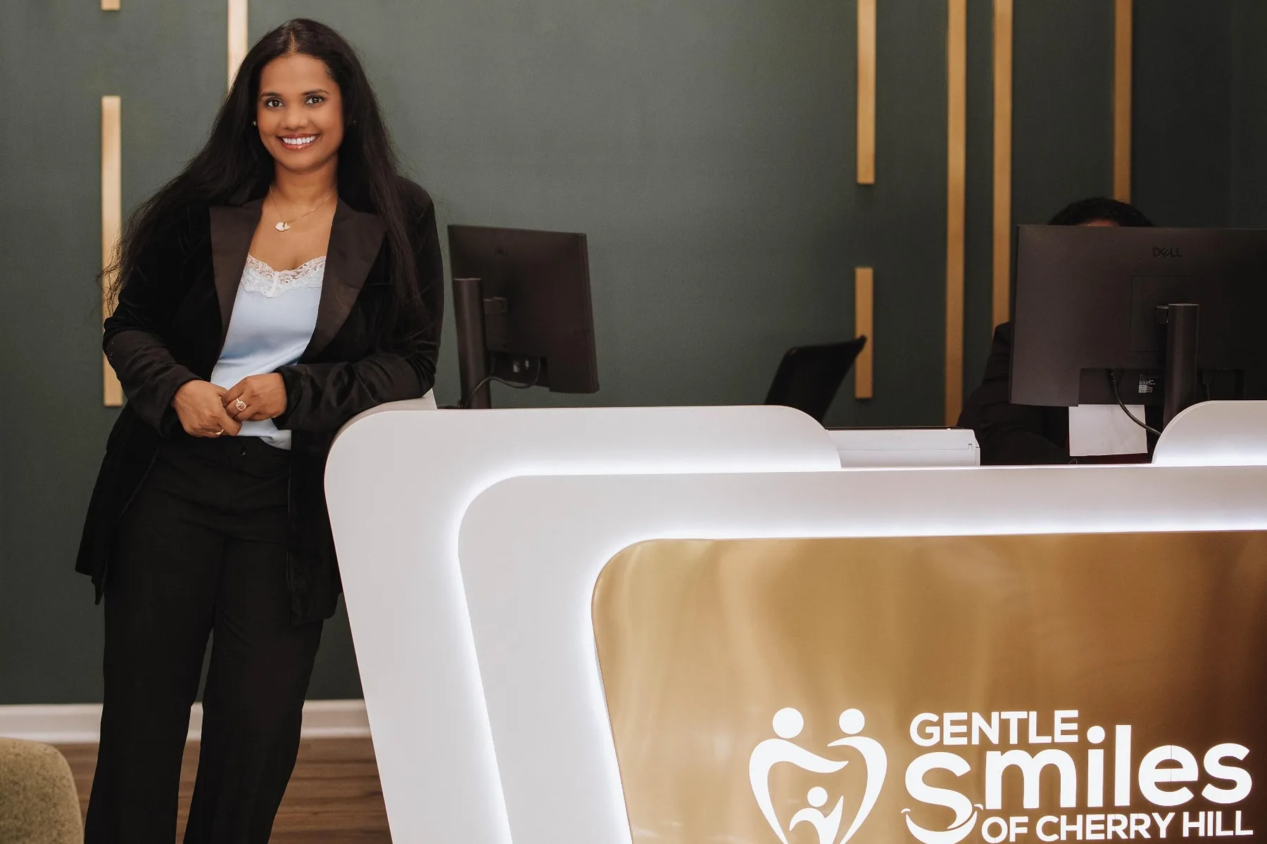 Dr. Sushmitha Jeeri at the front desk of Gentle Smiles of Cherry Hill, NJ